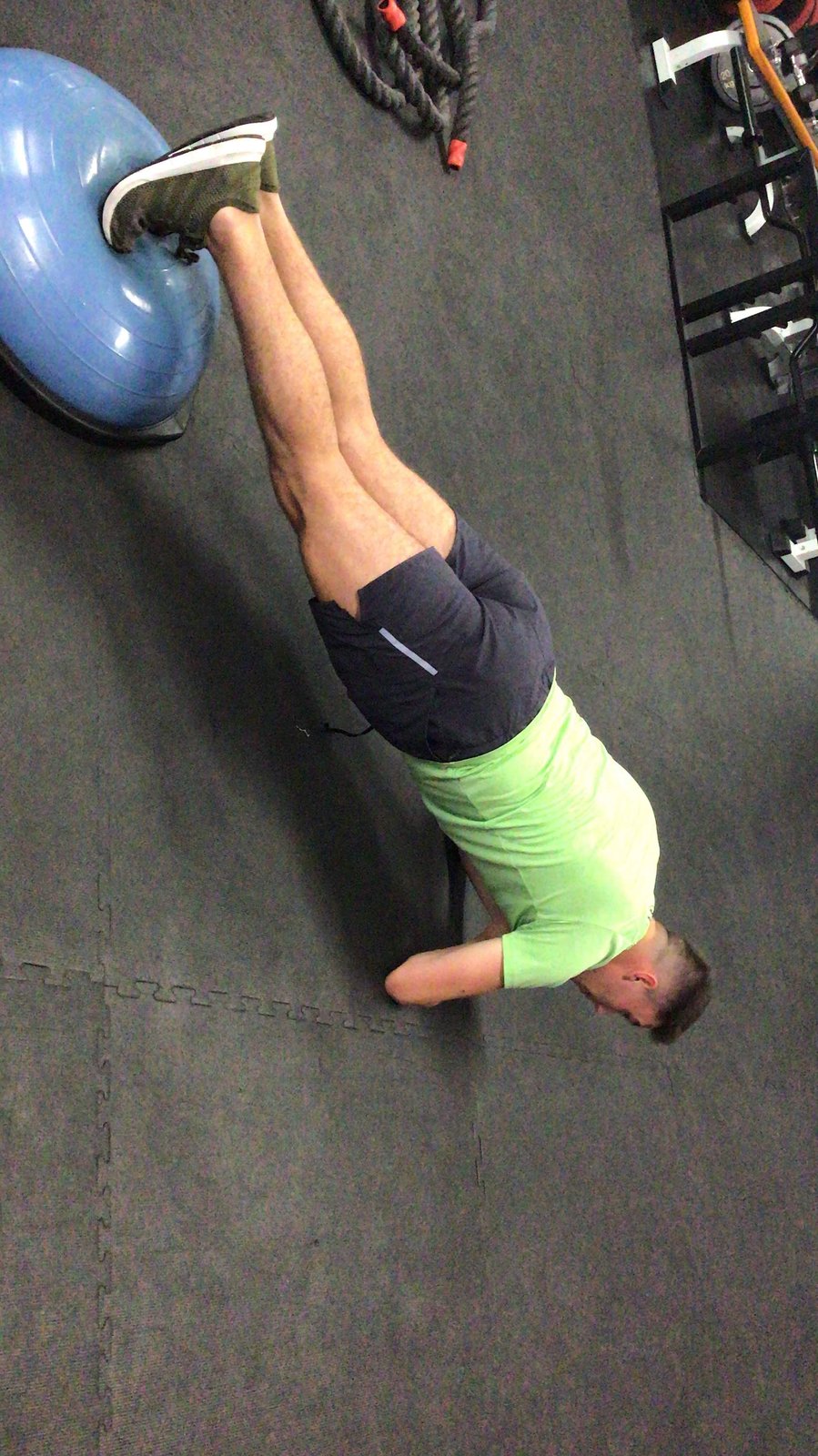 Plank core stability drill with feet on a bosu ball