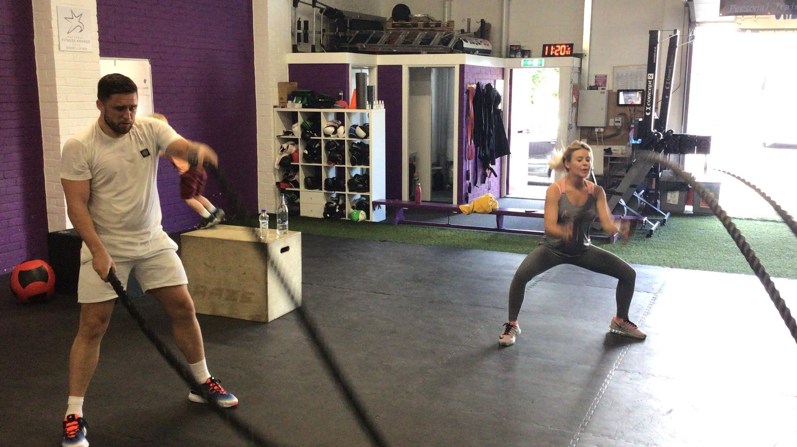 Battle rope conditioning session, two clients training together
