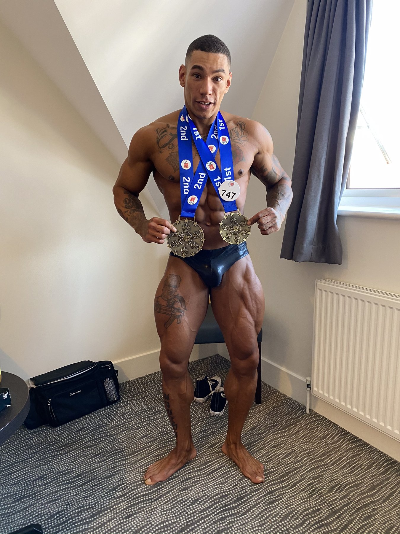Jonny Goodall, founder of Black & White Coaching, with competition medals