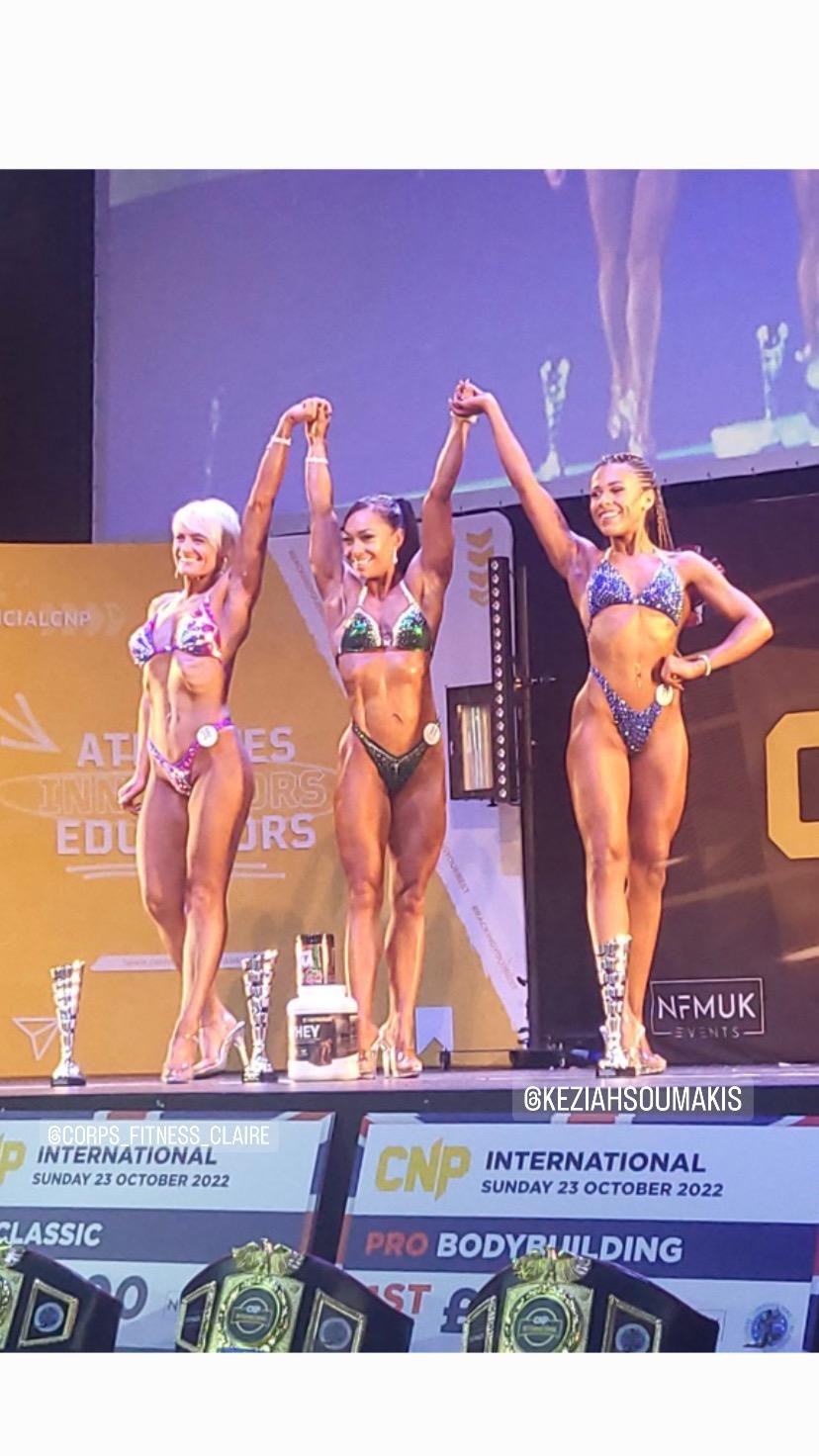 Clients placing at a bodybuilding competition, holding trophies